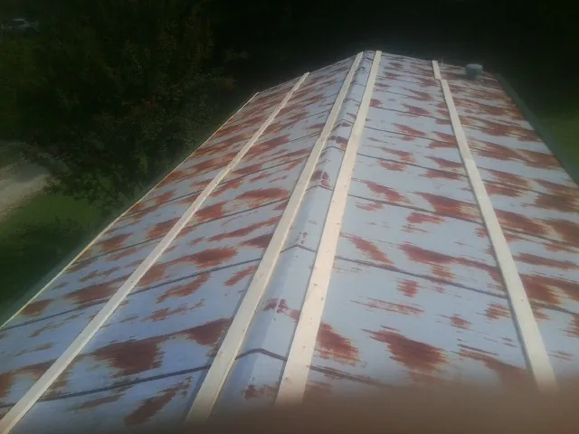 Rusted metal roof panels with new wood purlins before replacement — Storm Damage Roof Repair in Hoffman by Roofing Brothers