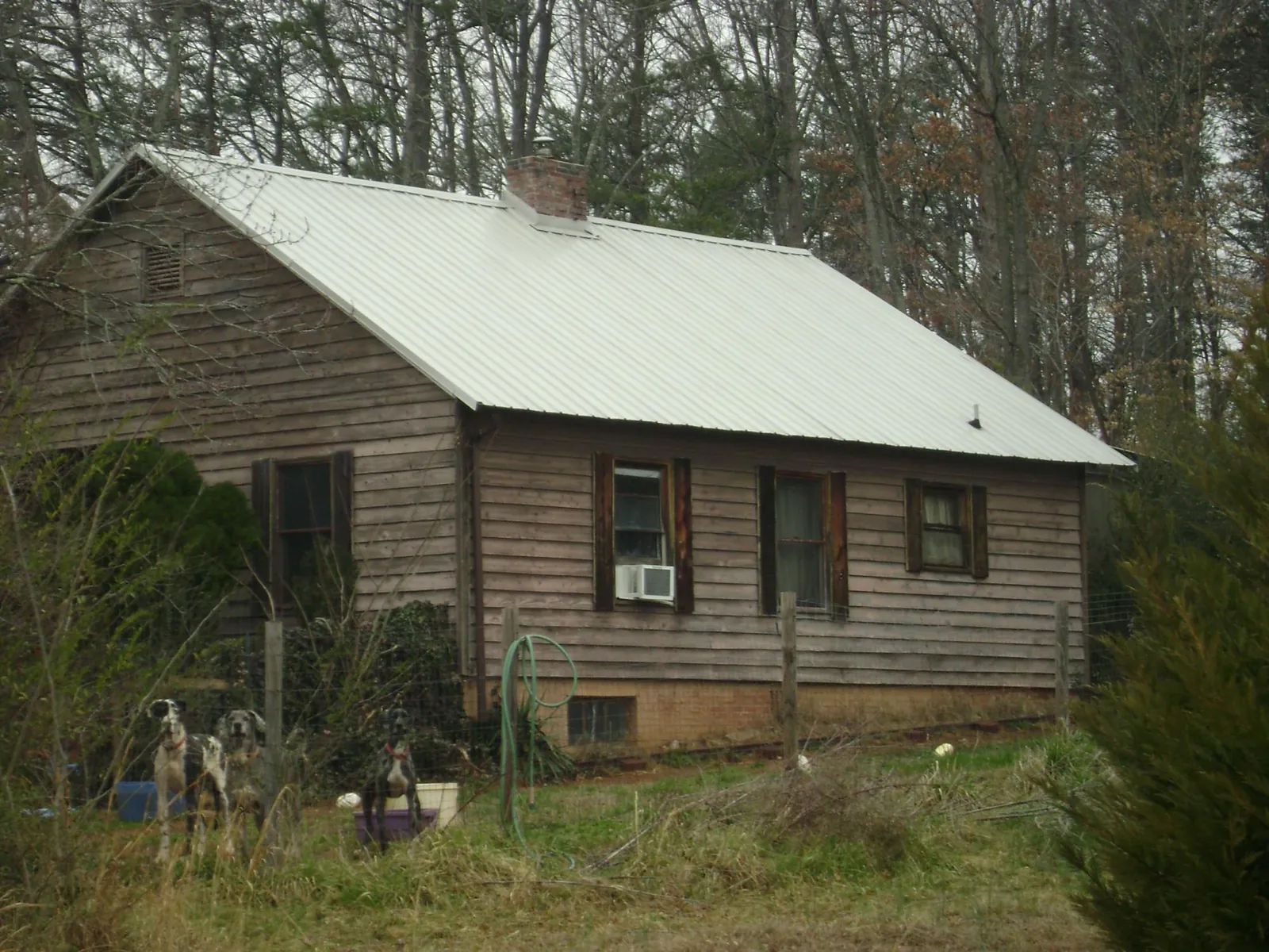 White metal roof on an old wood sided farmhouse, from a Metal Roof Installation job in Hoffman